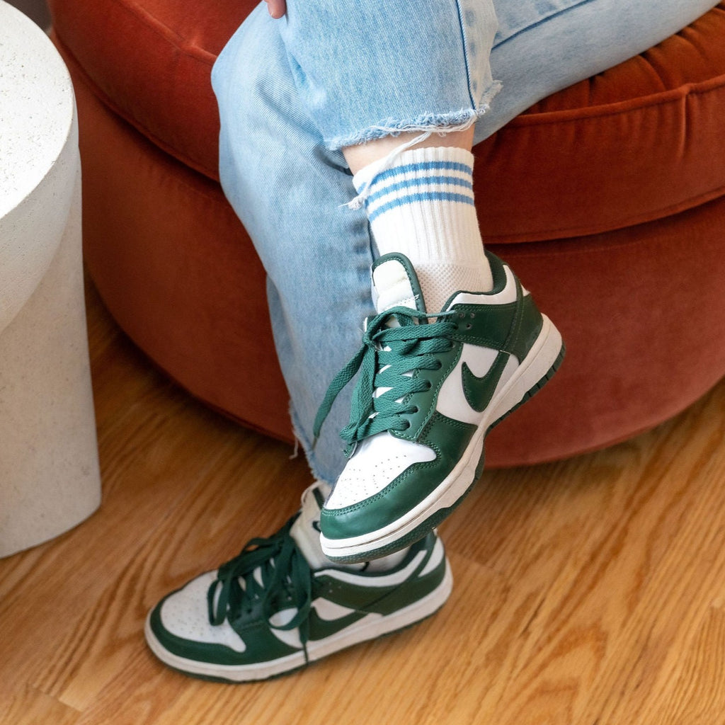 Ivory Tube Socks with Blue Stripes on Model with Green Sneakers at Golden Rule Gallery