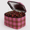 Pink plaid cooler bag filled with cherries on a white background