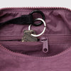 Purple bag with a key and keychain attached, showing a close-up of the zipper and fabric texture.