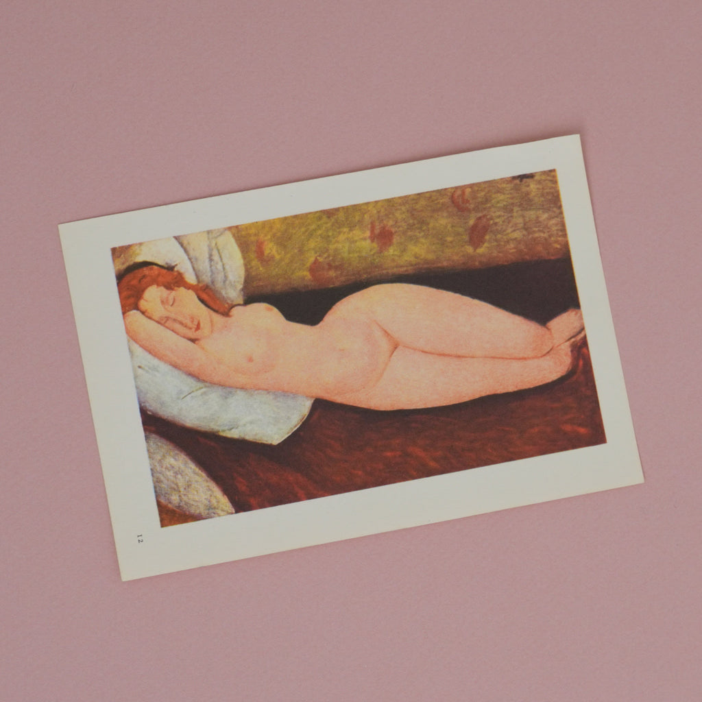 Artistic depiction of a reclining figure on a pink wall