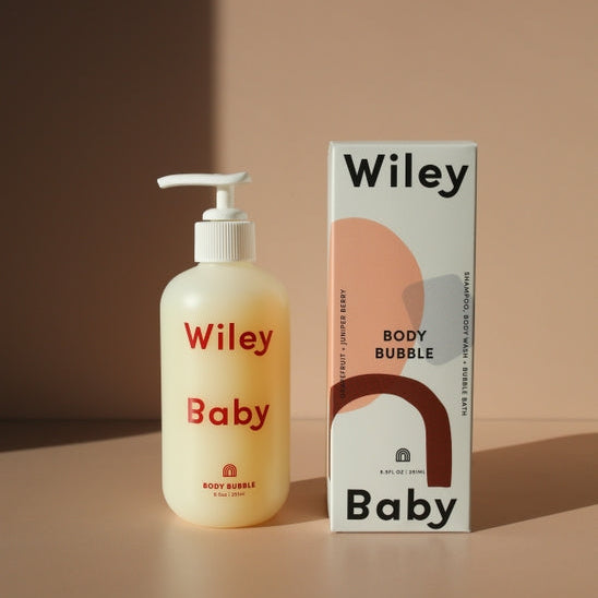 Wiley Baby body bubble bottle and packaging on a beige background