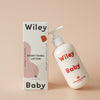 Wiley Baby lotion bottle and packaging on a beige background