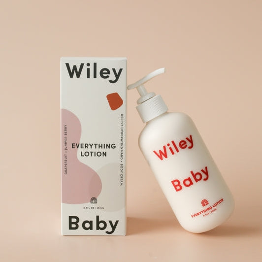 Wiley Baby lotion bottle and packaging on a beige background