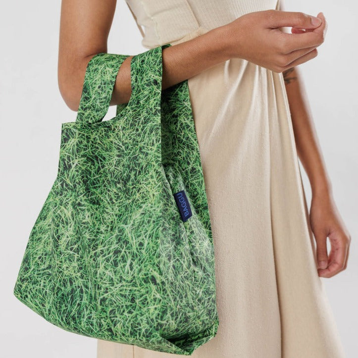 Model Holding Grass Baggu Baby Reusable Tote Bag