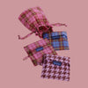 Set of plaid and patterned bags with 'BAGGU' labels on a white background