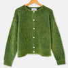 A green textured knit cardigan sweater with white buttons, hanging on a wooden hanger against a light gray background.