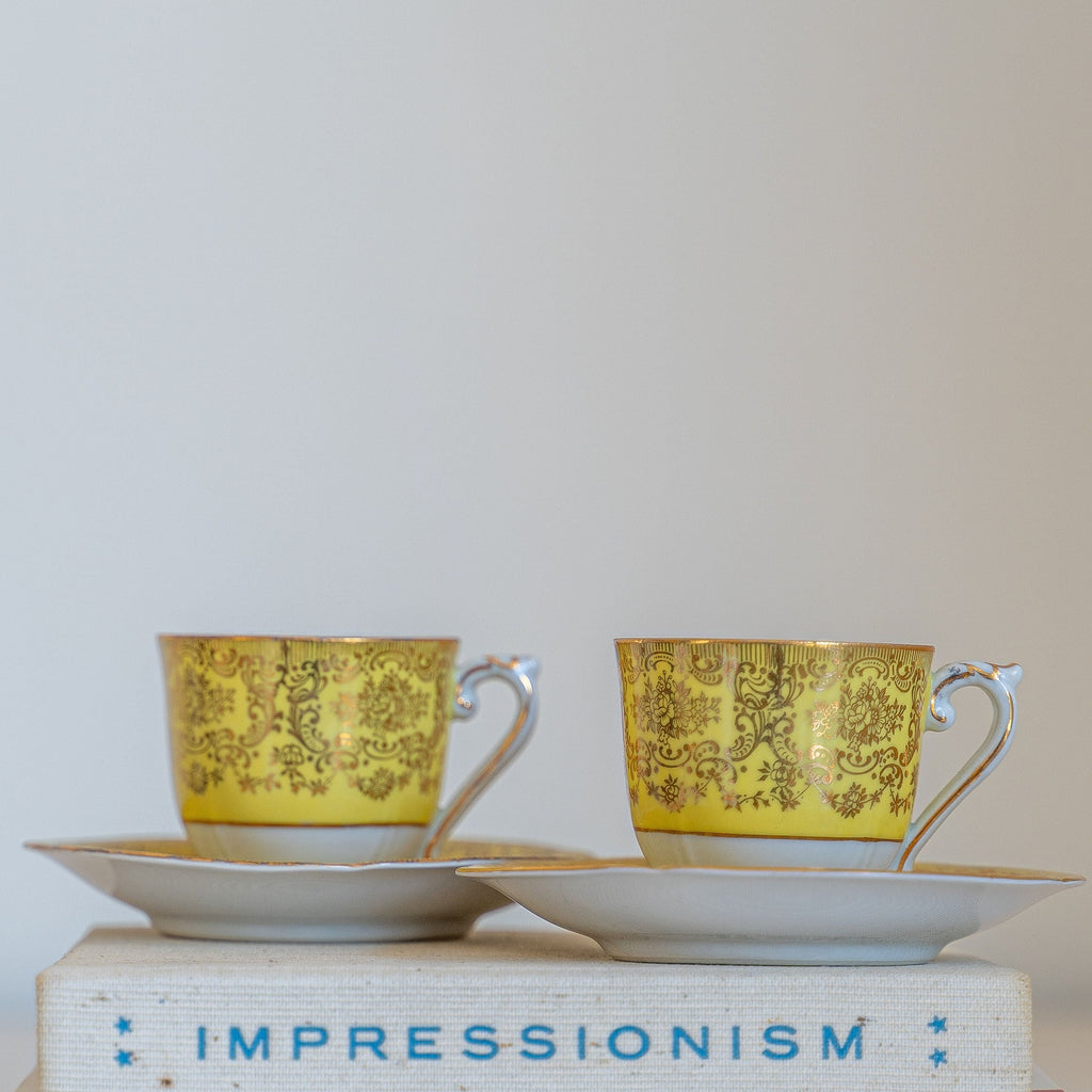 Set of Czech EPIAG demitasse cup and saucers in gold and yellow.
