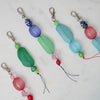 Colorful beaded keychains on a marble surface