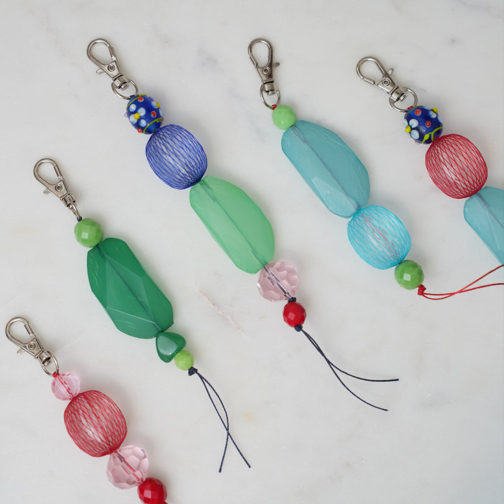 Colorful beaded keychains on a marble surface