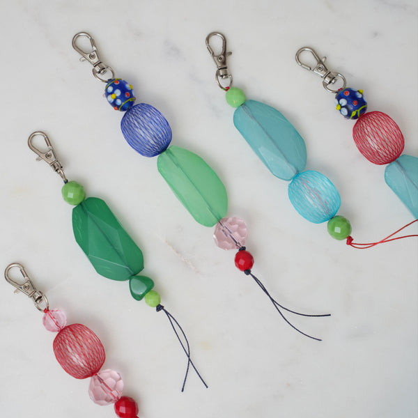 Colorful beaded keychains on a marble surface