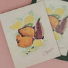 Framed artwork of pears and lemons on a pink background
