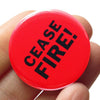 Cease Fire! Pinback Social Alert Button by Word for Word at Golden Rule Gallery in Minneapolis
