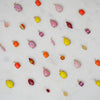 Colorful glass bead Charms on a light gray background