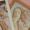 Framed and unframed vintage-style artwork of a woman with flowing hair on a pink background