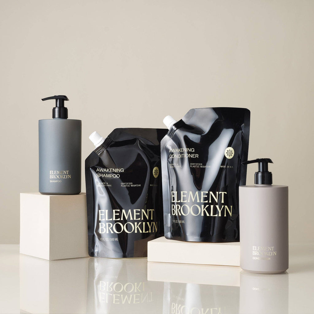 Element Brooklyn shampoo and conditioner bottles on a neutral background
