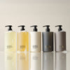 Five bottles of Element Brooklyn products on a reflective surface with a neutral background