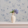 Cream vase with lilacs