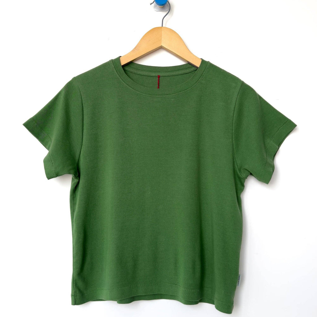 Green t-shirt by Le Bon Shoppe on a wooden hanger against a white background