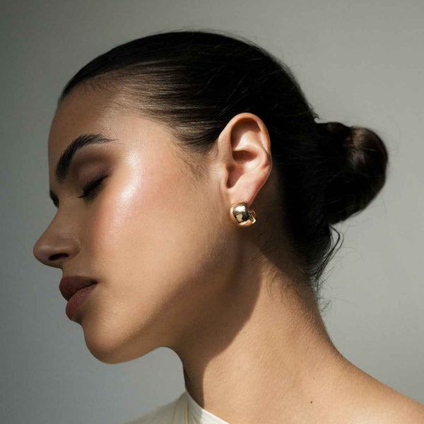 Woman with Classic Gold Earrings at Golden Rule Gallery in Excelsior, MN