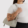 Model Holding Baggu Loaf Bag in Sage Stripe