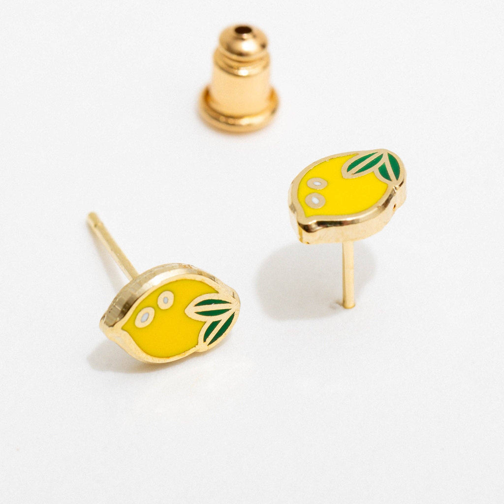 Lemon-shaped earrings with gold accents on a white background