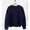 A dark navy blue fuzzy knit sweater hanging on a wooden hanger with a blue hook against a plain white background.