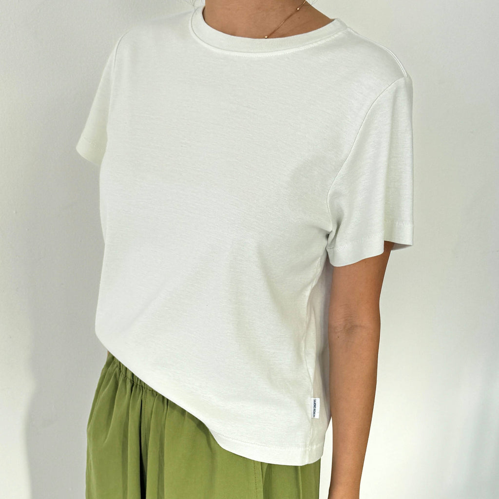 Model in Le Bon Shoppe Noel Tee in Chalk and Green Parachute Pants