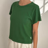 Green Le Bon Shoppe t-shirt worn by a person on a plain background