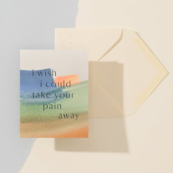Greeting card with 'I wish I could take your pain away' text and watercolor design, accompanied by a matching envelope.
