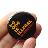 No One is Illegal on Stolen Land Pin Button at Golden Rule Gallery in Excelsior