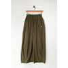 Olive green wide-leg pants on a hanger against a white background
