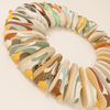 Colorful patterned shoes arranged in a circular formation on a light background
