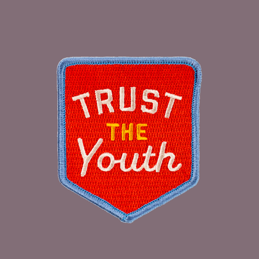 Red patch with 'Trust the Youth' text on a white background