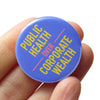 Blue Pinback Button that reads "Public Health Over Corporate Wealth" 