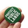 Green p in button with 'Protect Public Lands' text by Word for Word