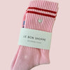 Pink boyfriend sock with red stripes and a heart detail, labeled 'Le Bon Shoppe' on a pink background.
