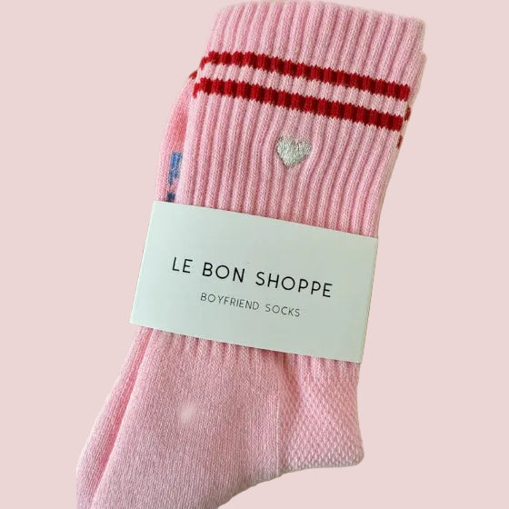Pink boyfriend sock with red stripes and a heart detail, labeled 'Le Bon Shoppe' on a pink background.
