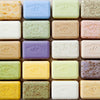 Assorted bars of soap from Pre de Provence arranged in a grid.