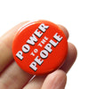 Red "Power To The People" Activism Pin Back Button at Golden Rule Gallery