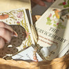 Book titled 'The Serviceberry' with decorative elements in a woven basket.
