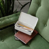 White box with stationery items on a green cushioned chair
