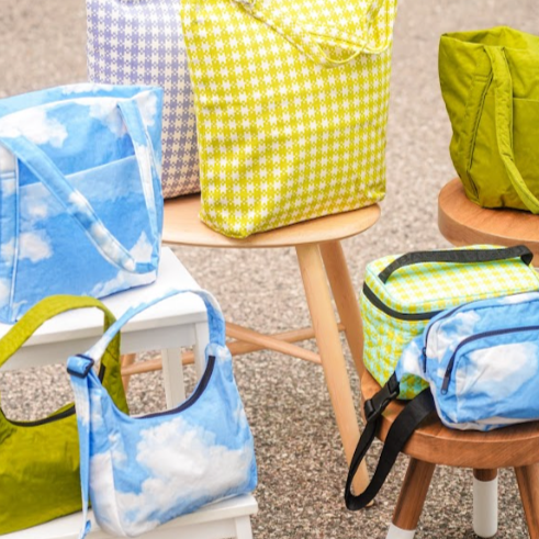 Avocado And Clouds Print Baggu Small Nylon Shoulder Bag Styled On Stools With Vibrant Baggu Bags