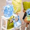 Avocado And Clouds Print Baggu Mini Nylon Shoulder Bag Modeled On Step Stool With Colorful Baggu Bags