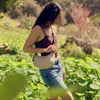 Model Wearing The Baggu Small Nylon Crescent Bag In Brown Stripe