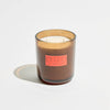 Candle with a 'Smoked Cherry' label on a light gray background