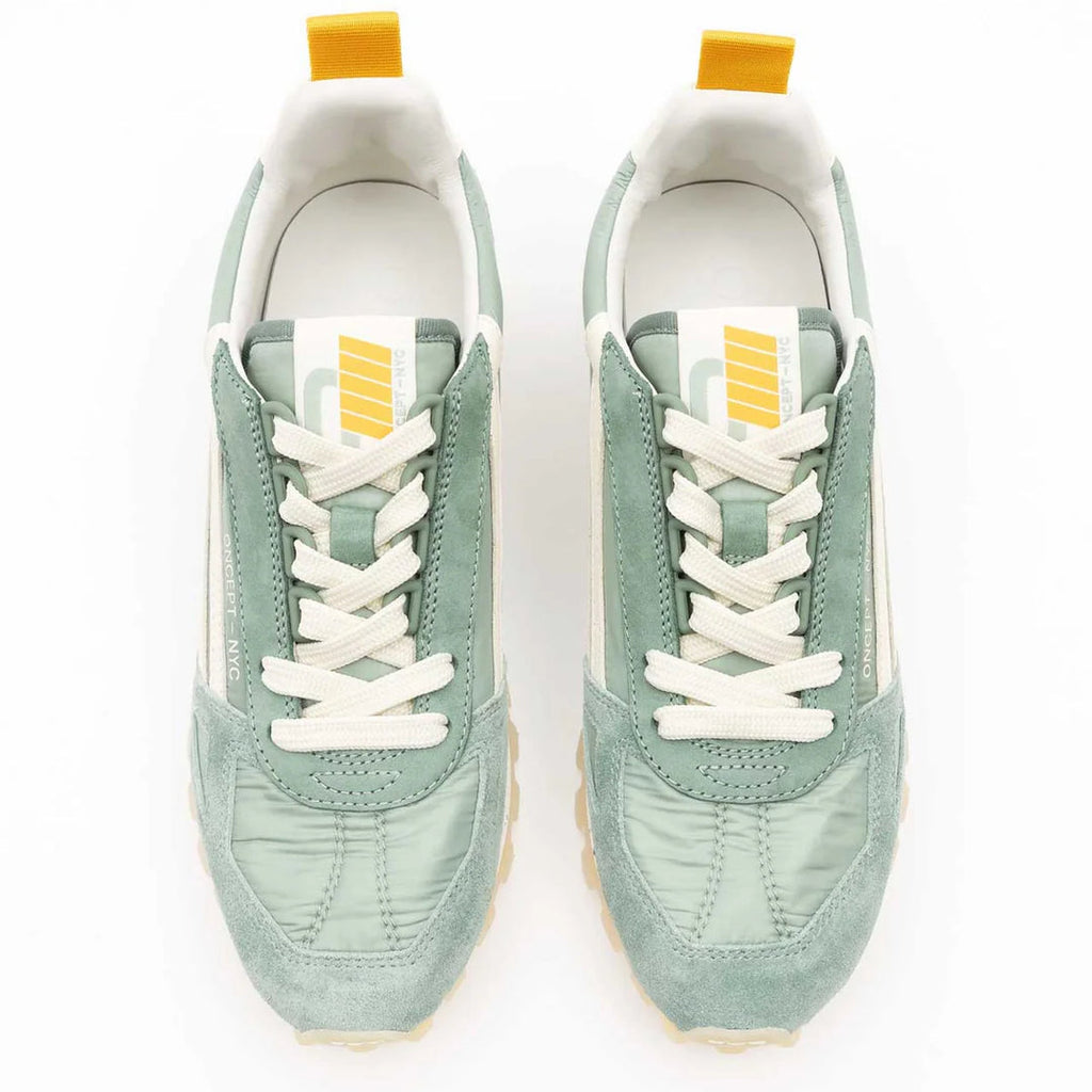 Pair of light green sneakers with white laces on a white background