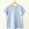 Light blue t-shirt by Le Bon Shoppe on a wooden hanger against a white background
