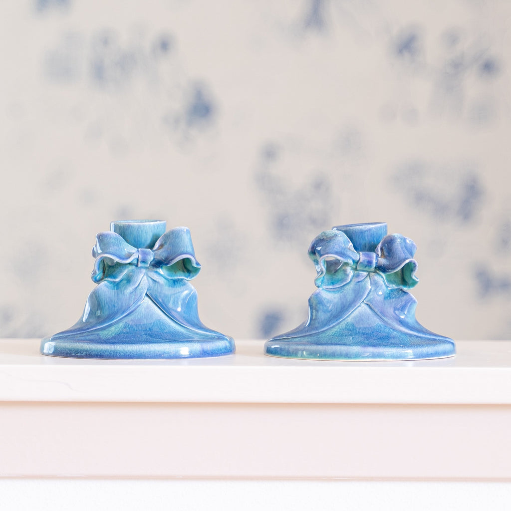 Pair of two blue bow taper candle stick holders at Golden Rule Gallery