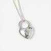 Close Up of Wolf Circus Heart necklace in Sterling Silver