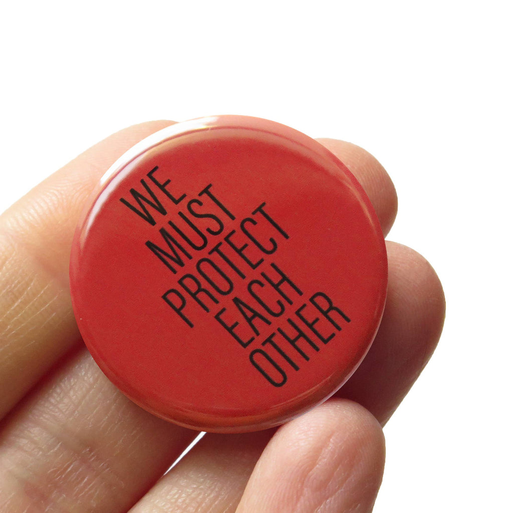 We Must Protect Each Other Social Alert Pinback Button at Golden Rule Gallery